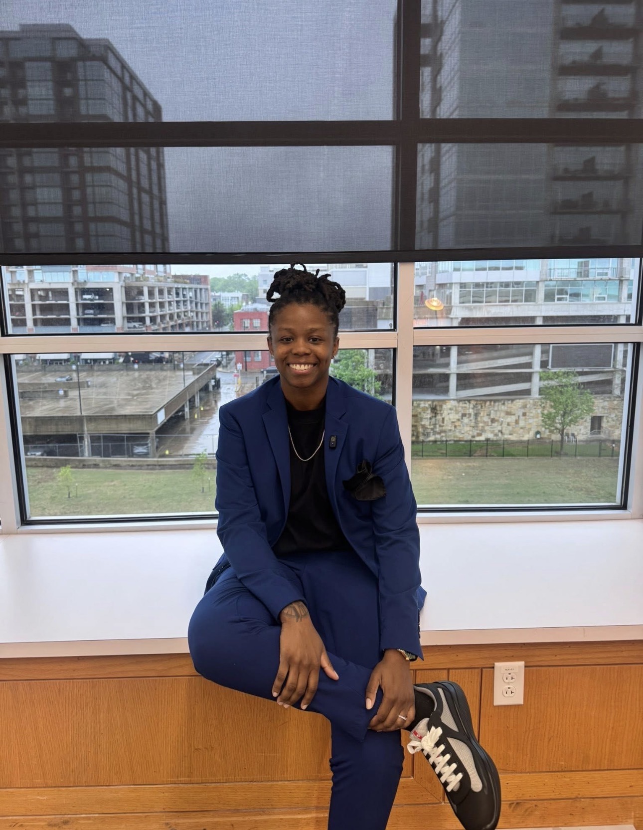 Lexis James, founder of Knowledge 2 Success, wearing a navy suit